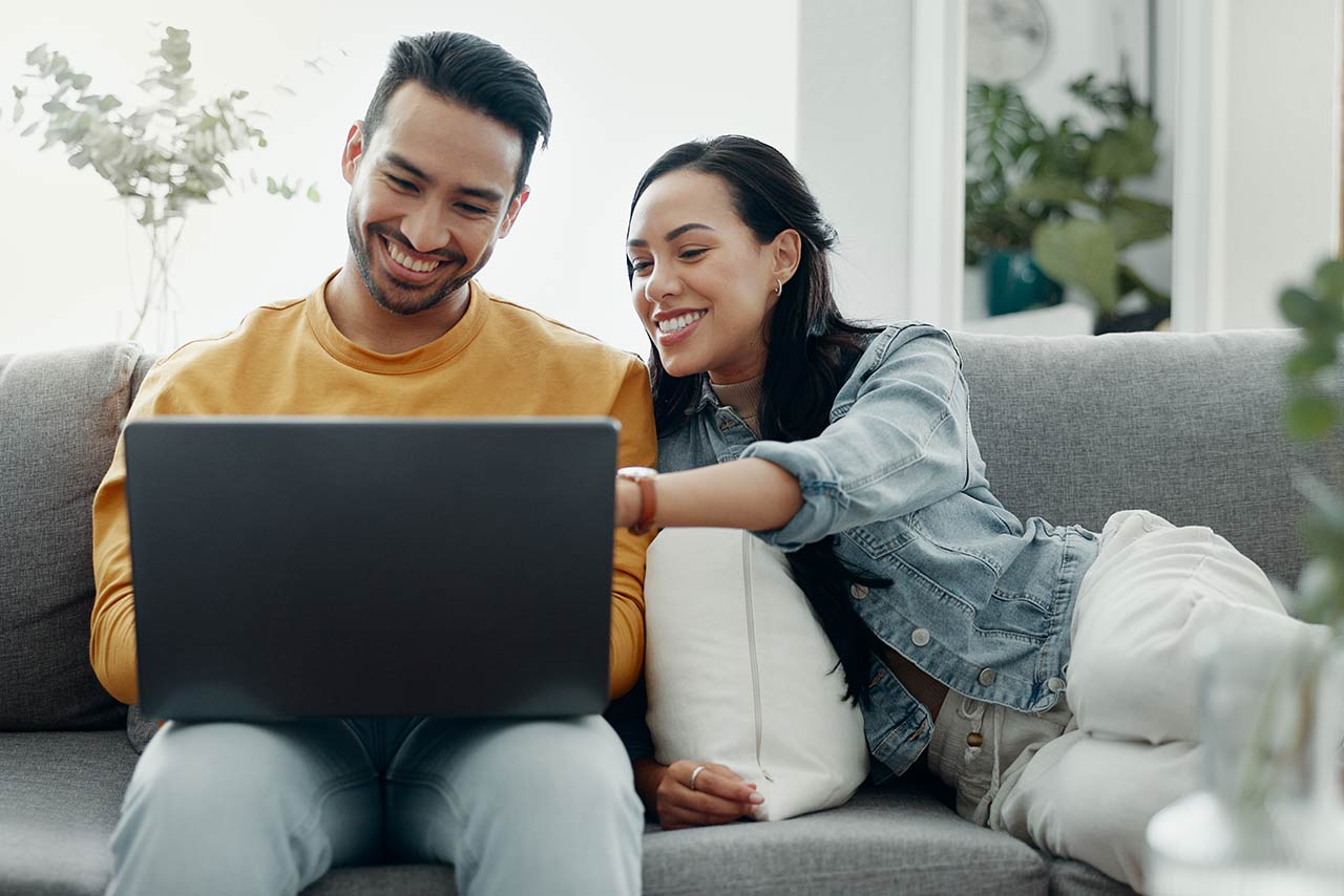 Home laptop, smile and relax couple search internet